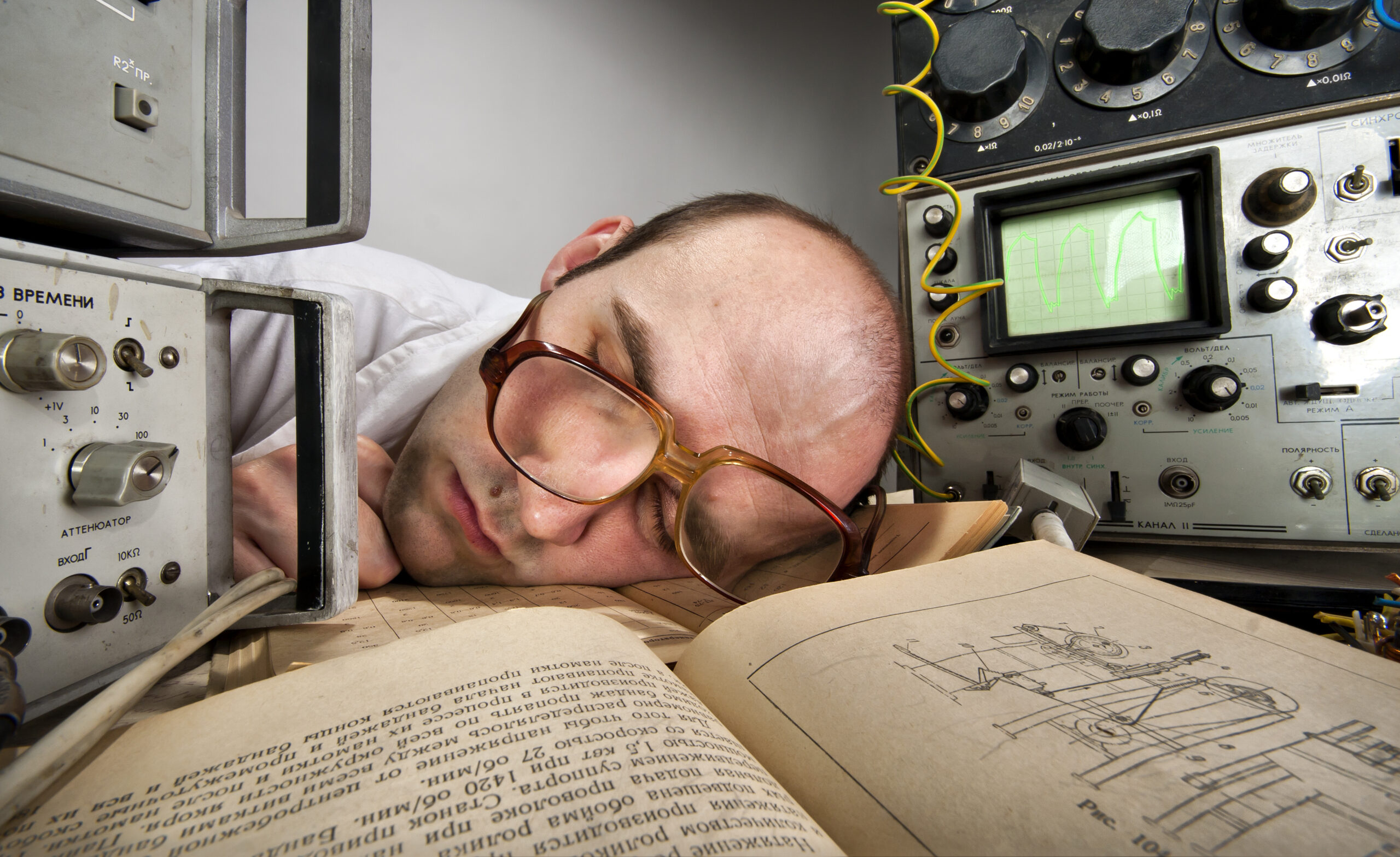 Exhausted scientist sleeping on book