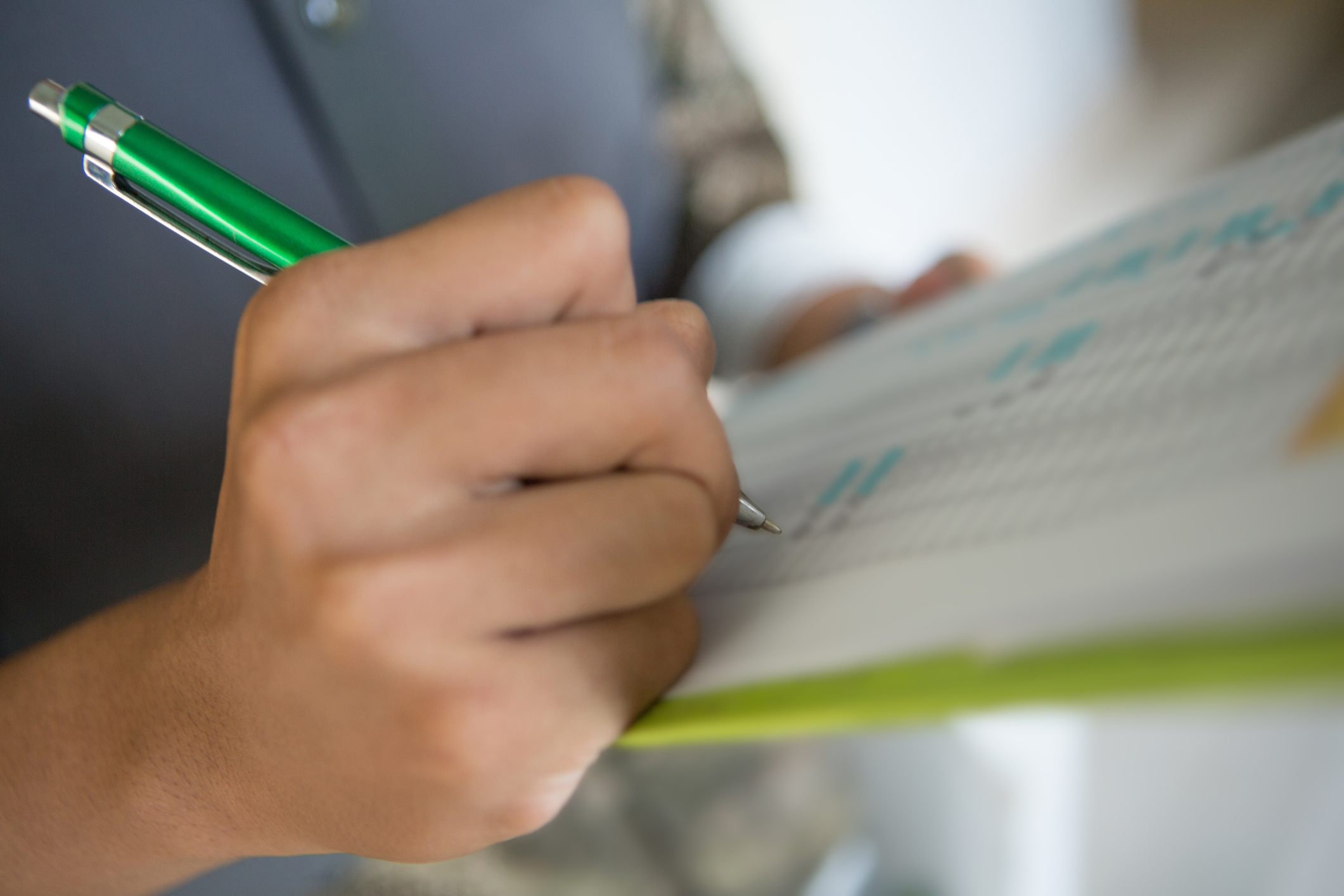 Human hand writing down on checklist, selective focus